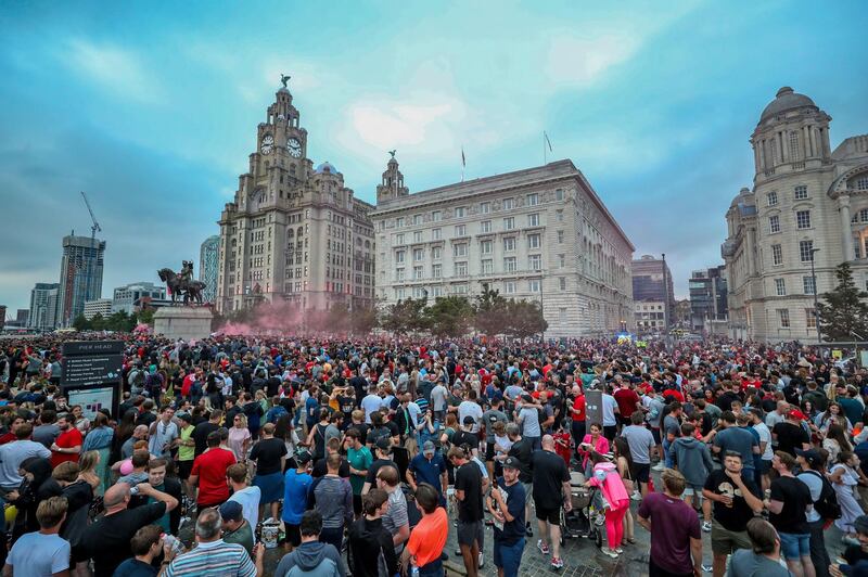 Liverpool fans let off flares outside the Liver Building in Liverpool. PA