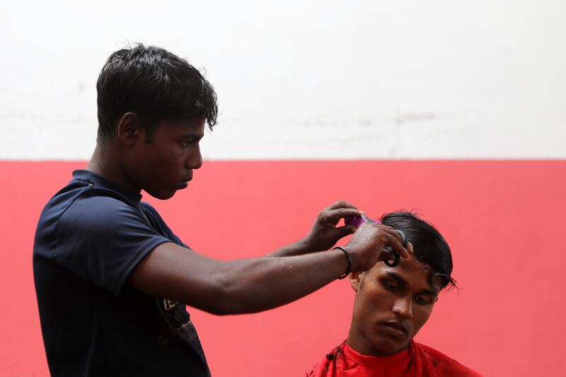 A Rohingya refugee gets a haircut at a temporary shelter provided by the local government in Pidie, Indonesia.  EPA 