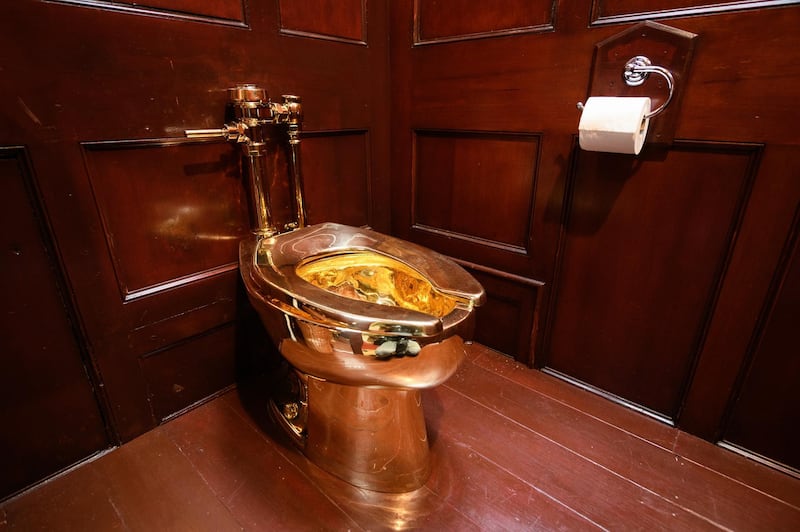 WOODSTOCK, ENGLAND - SEPTEMBER 12: "America", a fully-working solid gold toilet, created by artist Maurizio Cattelan, is seen at Blenheim Palace on September 12, 2019 in Woodstock, England.  The Italian artist is known as the prankster of the art world.  His most notable piece being "America" a solid gold usable toilet which had art lovers queuing to use when it was shown at the Guggenheim Museum in New York. (Photo by Leon Neal/Getty Images)