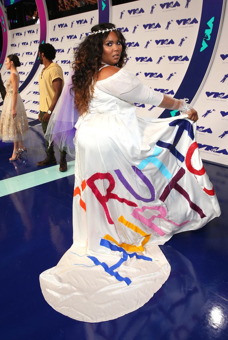Lizzo wears a white dress with 'Truth Hurts' written in multi-coloured letters to the 2017 MTV Video Music Awards in Inglewood, California. Getty Images
