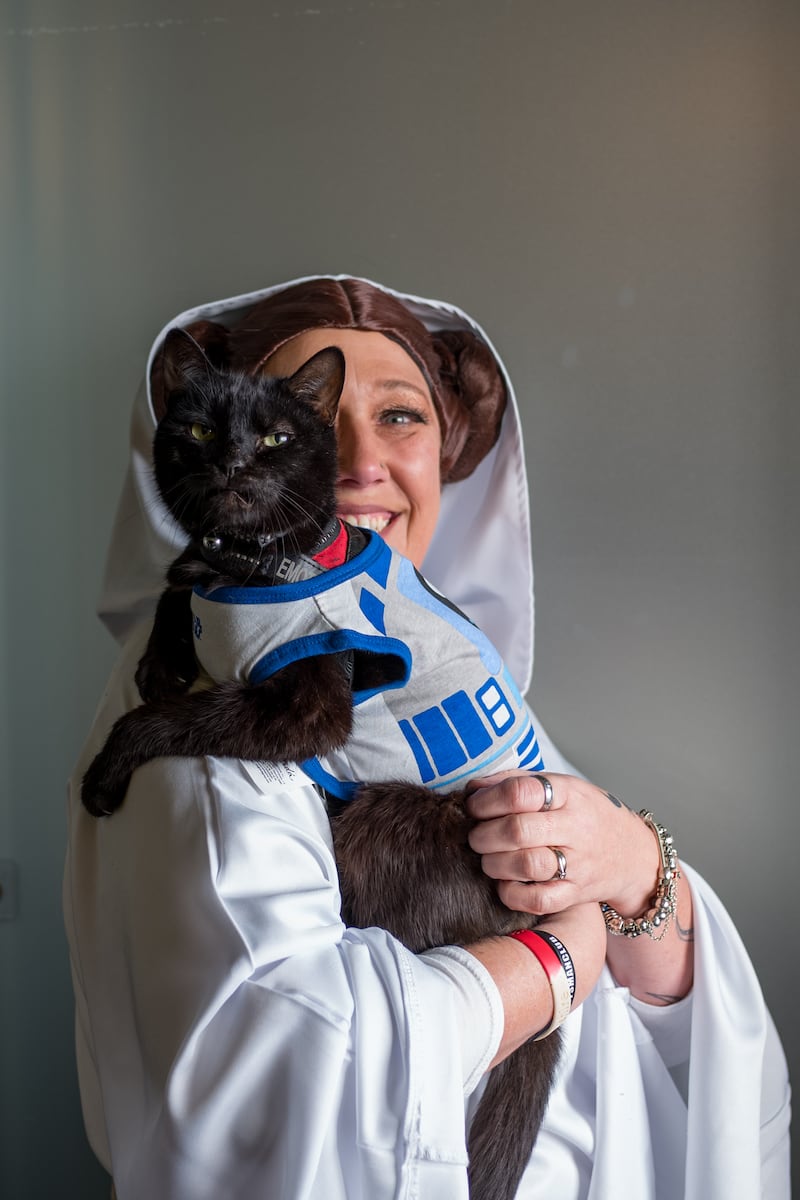 Sharon Morley of Huddersfield poses with her cat, Atticus Finch, who is dressed as a Star Wars droid to raise money for charity