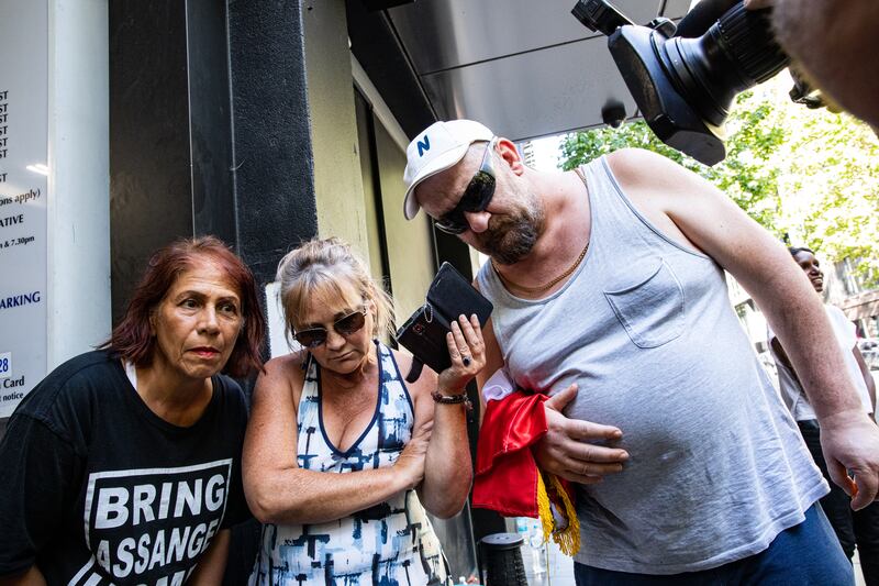 Supporters of Serbian tennis player Novak Djokovic gather outside the offices of Djokovic's legal team, as they listen to an audio court hearing. Getty Images
