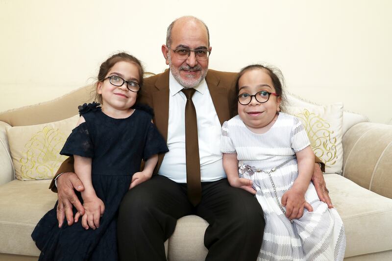 Samir Hamasha with his daughters Saba, left, and Bushra, right, who both have a rare disease called MPS 6. Pawan Singh / The National