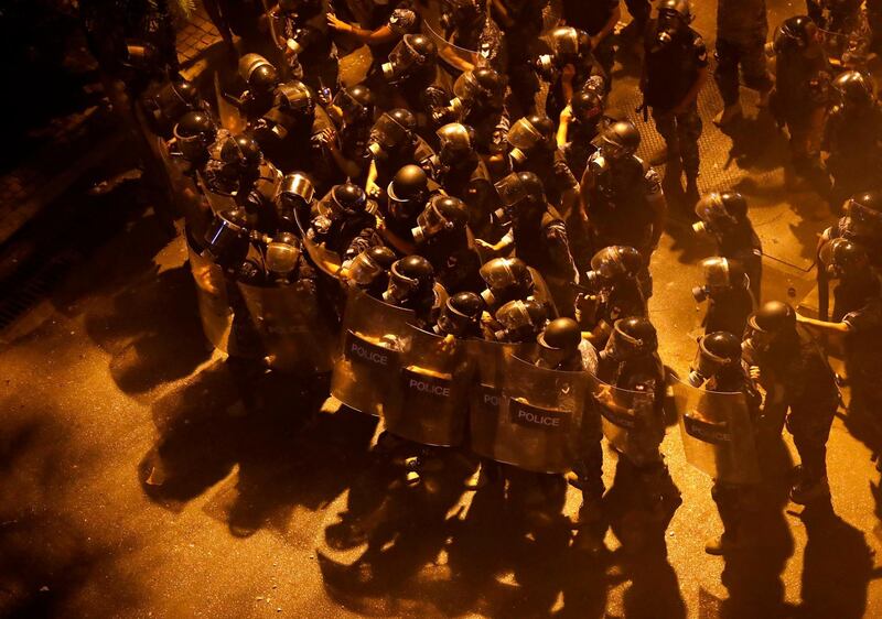 Riot police advance to push back demonstrators from a square near the government house in downtown Beirut, Lebanon. AP Photo
