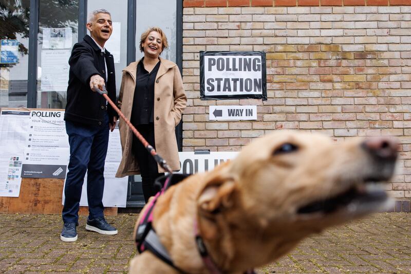 London mayor Sadiq Khan and his wife Saadiya pose for the media with their dog Luna, as they arrive at a polling station in the British capital. EPA