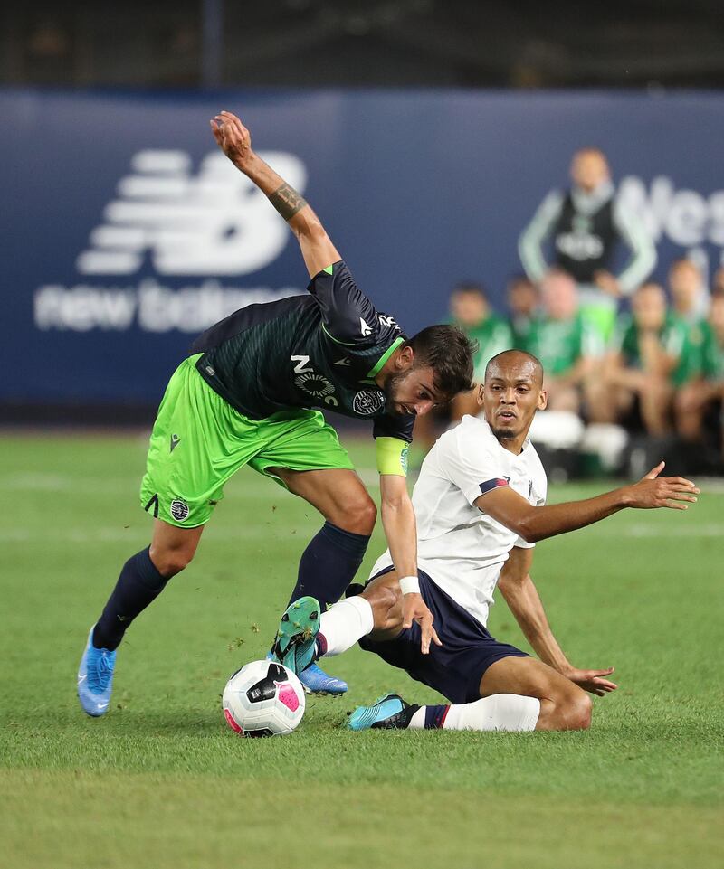 Bruno Fernandes of Sporting and Fabinho of Liverpool, right, battle for the ball. AFP