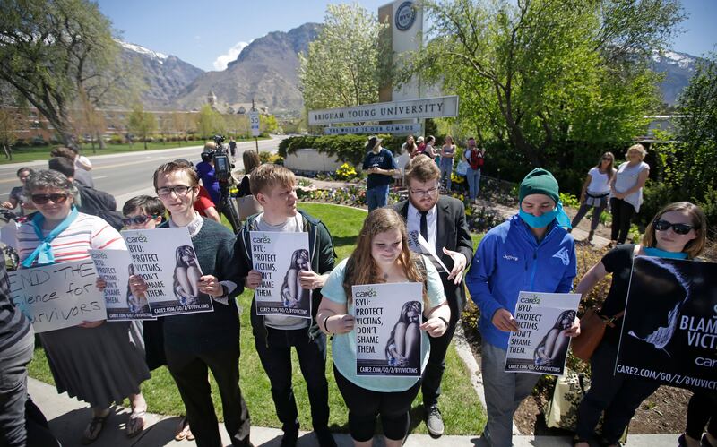 Protesters stand in solidarity with rape victims on the campus of Brigham Young University in Provo, Utah. The administration of President Joe Biden proposed a major overhaul of campus sexual assault rules in June 2022 to bolster the rights of victims and widen universities' responsibilities in addressing misconduct. AP