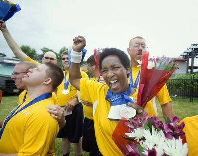 Goalie Loretta Claiborne, right, and her teammates on Pennsylvania's Traditional 5V5 Division 3 Special Olympics soccer team celebrate their 4-1 victory over Michigan, which clinched the Division 3 title in Hamilton Township, N.J., Thursday, June 19, 2014. (AP Photo/The Philadelphia Inquirer, Ed Hille)