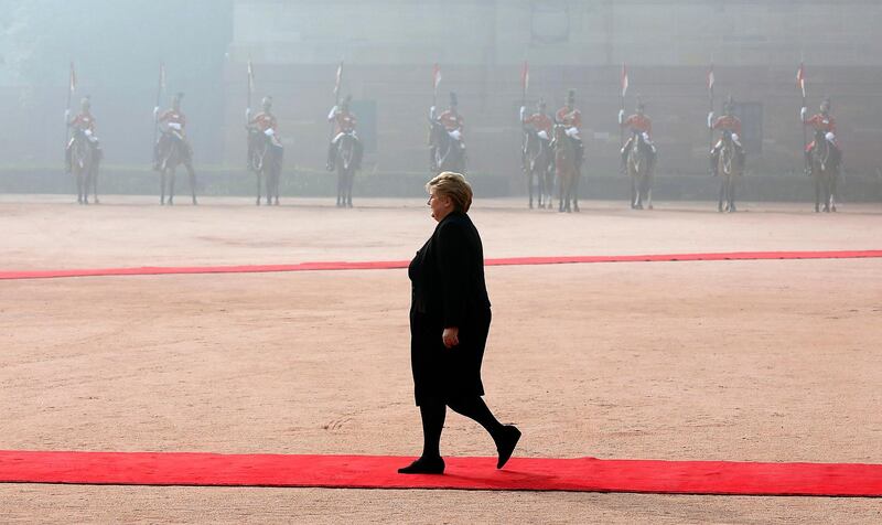 Norwegian Prime Minister Erna Solberg walks on the red carpet after inspecting the guard of honor during her ceremonial reception at the president's house in New Delhi, India. EPA