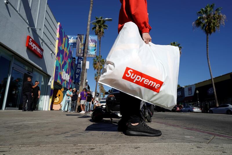 A shopper holds a bag full of purchases from the Supreme clothing store on Fairfax, in Los Angeles, California, October 31, 2019. Picture taken October 31, 2019. REUTERS/Mike Blake
