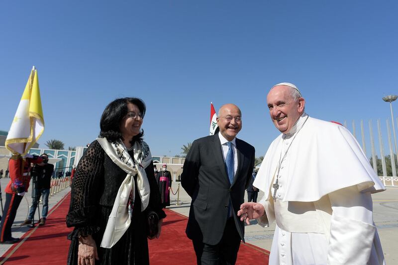 Pope Francis is accompanied by Iraq's President Barham Salih and his wife Sarbagh Salih before departing for Rome, at Baghdad International Airport in Baghdad, Iraq March 8, 2021. Vatican Media/?Handout via REUTERS    ATTENTION EDITORS - THIS IMAGE WAS PROVIDED BY A THIRD PARTY.