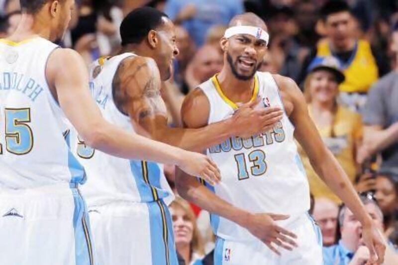 From left, Denver Nuggets forward Anthony Randolph joins guard Andre Iguodala in congratulating forward Corey Brewer after a basket. The Nuggets are relying on team play more than an individual superstar's act, as they have no big-name player.