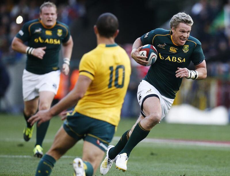 Jean de Villiers, right, helped lead South Africa's charge past Quade Cooper and Australia in the Springboks' 28-8 over the Wallabies at Cape Town. Mike Hutchings / Reuters 