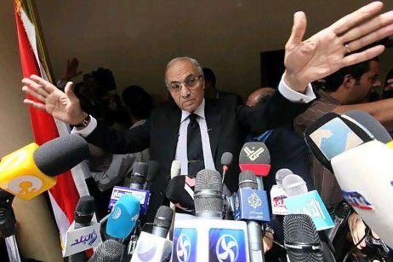 Egyptian presidential candidate Ahmed Shafiq waves to supporters before a press conference Saturday in Cairo.