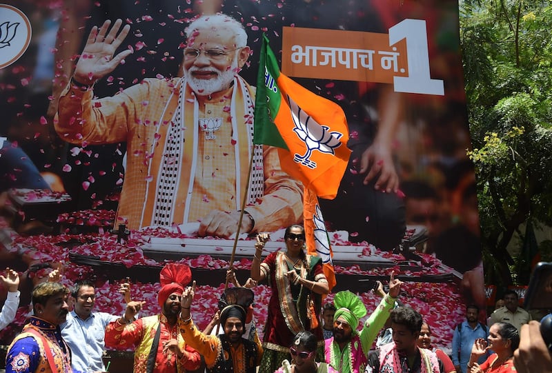 Supporters of Indian Prime Minister Narendra Modi and his ruling Bharatiya Janata Party (BJP) celebrate the election results outside the BJP headquarters in Mumbai. AFP