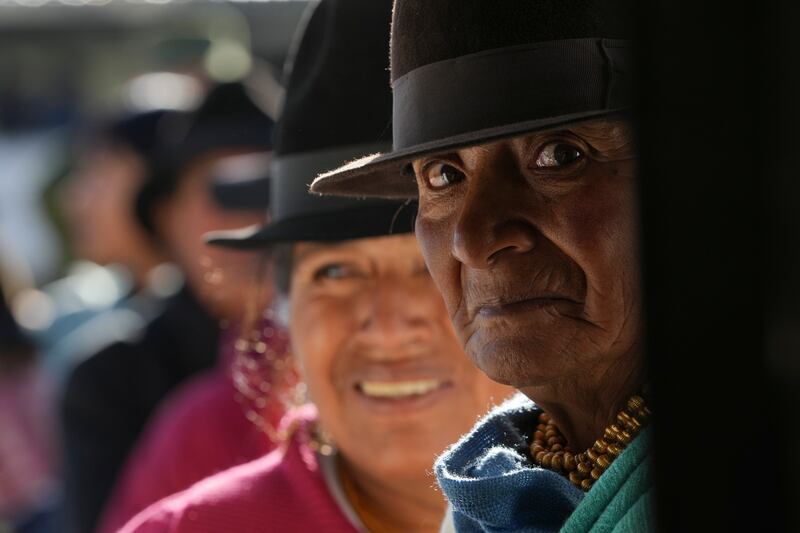 Voters line up at a polling station during a run-off presidential election in Cangahua, Ecuador. AP