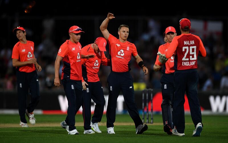 England bowler Tom Curran, centre, celebrates taking the wicket of Martin Guptill. Getty