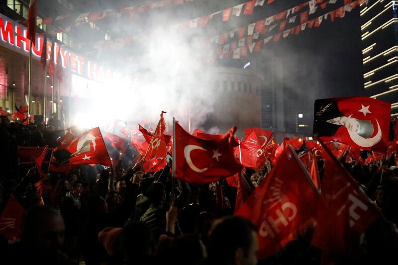 Supporters of the CHP wave Turkish flags as they celebrate after preliminary results of the local elections in Ankara. AP Photo