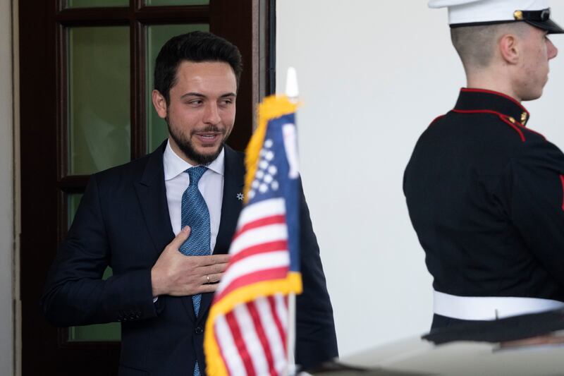 Prince Hussein leaves the White House after a lunch with Mr Biden. AP