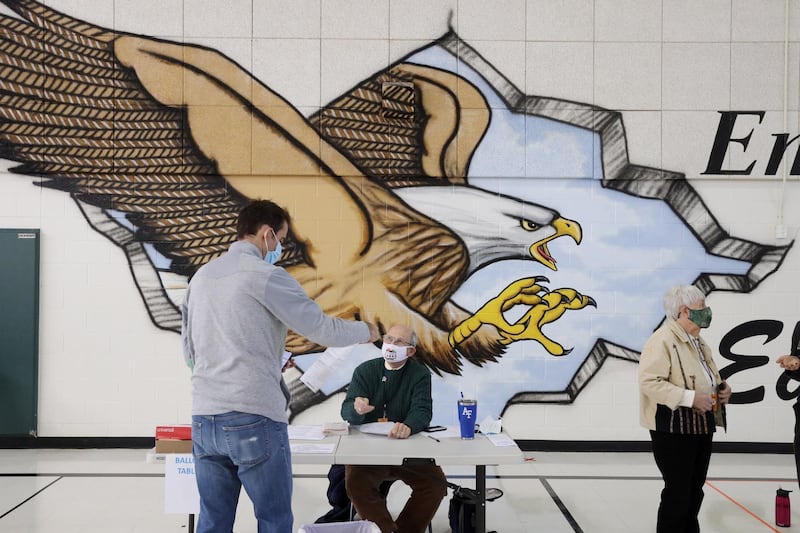 A voter is assisted by a polling station worker at a polling location inside Emerick Elementary School in Purcellville, Virginia.  EPA