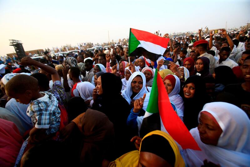 Supporters of the deputy head of Sudan's ruling Transitional Military Council (TMC) and commander of the Rapid Support Forces (RSF) paramilitaries gather and cheer upon his arrival in the village of Qarri, about 90 kilometres north of Khartoum.  AFP