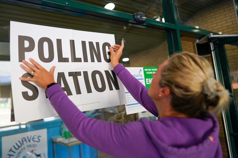 An official attaches a sign for the by-election on June 23, 2022 in Wakefield, England. Getty
