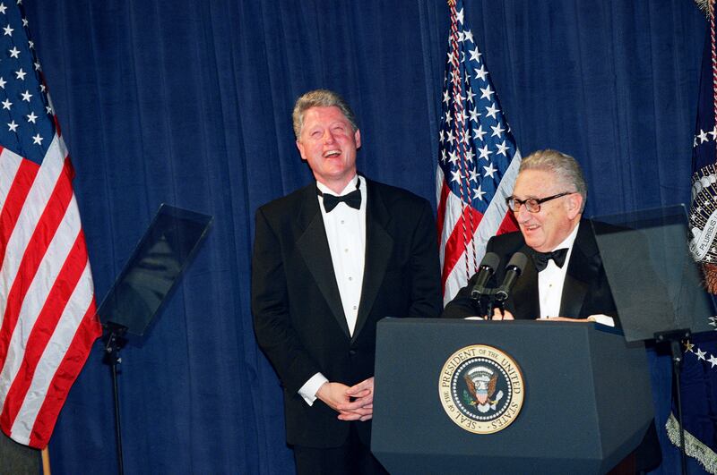US president Bill Clinton and Mr Kissinger share a joke at a national policy conference in Washington, in 1995. AP