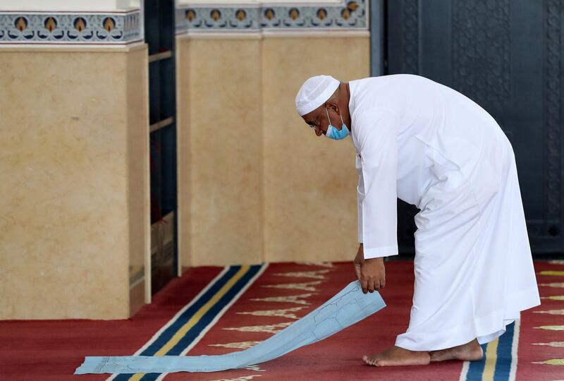 Dubai, United Arab Emirates - December 03, 2020: Lays down a disposable prayer mat at Al Farooq Omar Bin Al Khattab Mosque for midday prayers. Thursday, December 3rd, 2020 in Dubai. Chris Whiteoak / The National