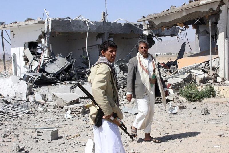 Houthi fighters inspect the damage caused by airstrikes on the airport of Yemen's northwestern city of Saada, a Houthi stronghold near the Saudi border on March 30, 2015. Naiyf Rahma/Reuters