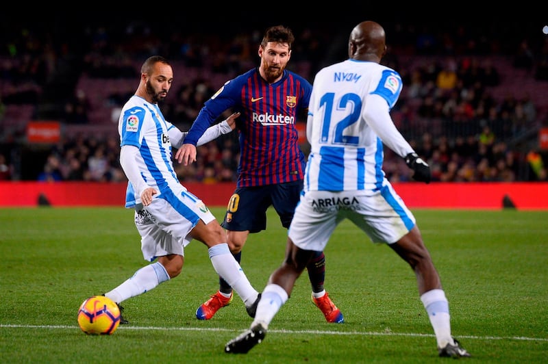 Lionel Messi in action against Leganes forward Nabil El Zhar defender Allan Nyom. AFP