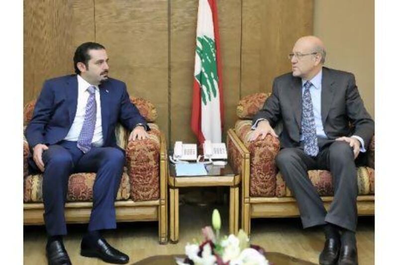 Najib Miqati, right, Lebanon's incoming prime minister, meets the outgoing premier, Saad Hariri, last week in Beirut.