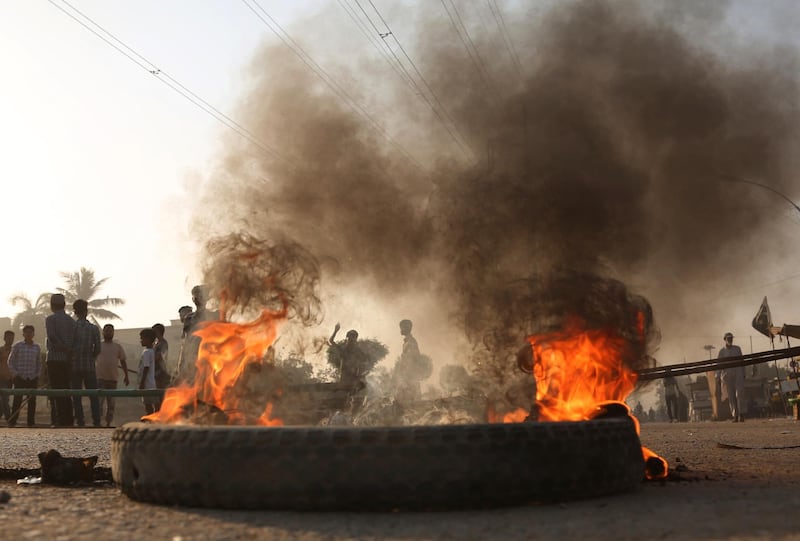 Pakistani protesters burn tires while blocking a main road during a protest after a court decision, in Karachi, Pakistan.  Asia Bibi, a Christian woman who spent eight years on death row under Pakistan's blasphemy law was acquitted and ordered released Wednesday by the country's top court, a ruling that raised fears of violence by religious extremists who held angry protests over the verdict. AP Photo