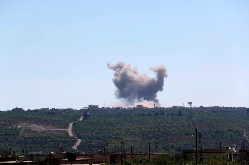 Smoke billows following bombardment by regime forces on the village of Ibdita in the Idlib province on May 4, 2019. The civil war in Syria has killed more than 370,000 people and displaced millions since it began in 2011 with anti-regime protests that sparked a devastating crackdown. / AFP / OMAR HAJ KADOUR
