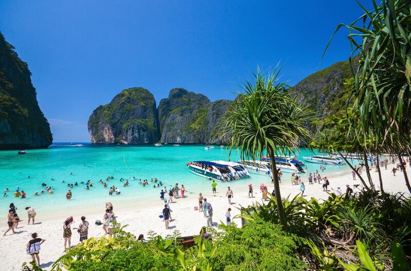 In this March 4, 2017, photo, tourists enjoy the popular Maya bay on Phi Phi island, Krabi province. Authorities have ordered the temporary closing of the beach made famous by the Leonardo DiCaprio movie "The Beach" to halt environmental damage caused by too many tourists. (AP Photo/Rajavi Omanee)