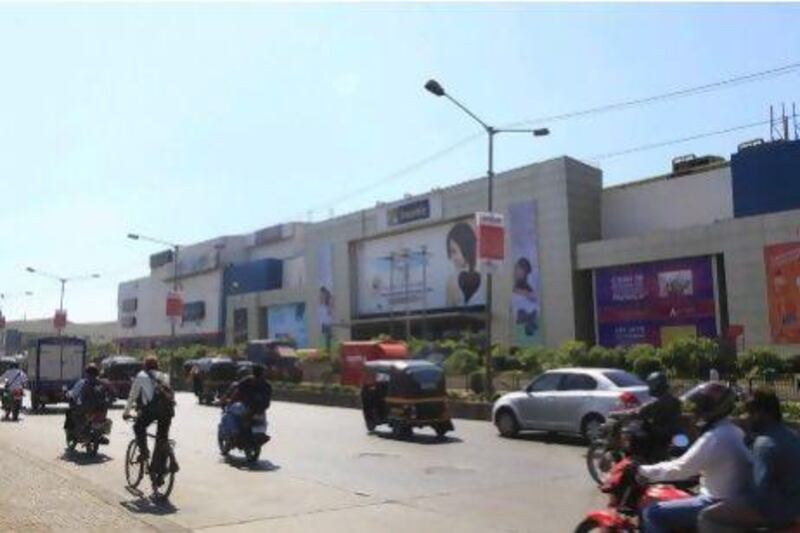 Traffic passes an Inorbit Mall in Mumbai. The Grand Venezia, 'India's first retail tourism destination', is under construction in Delhi.