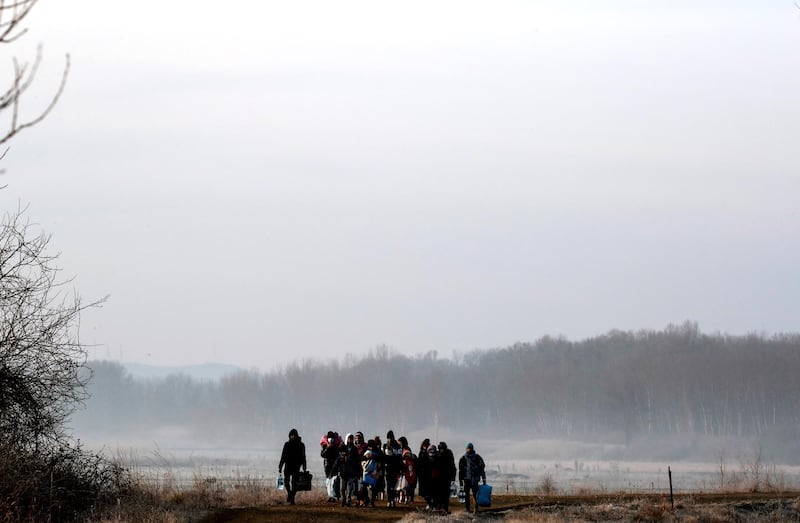 Migrants walk along the Evros river to reach Greece, near the Turkish border city of Edirne, Turkey. Reuters