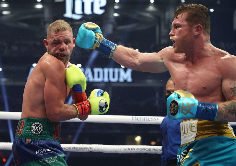 Saul Alvarez lands a punch on Billy Joe Saunders during their super middleweight title fight at AT&T Stadium. AFP