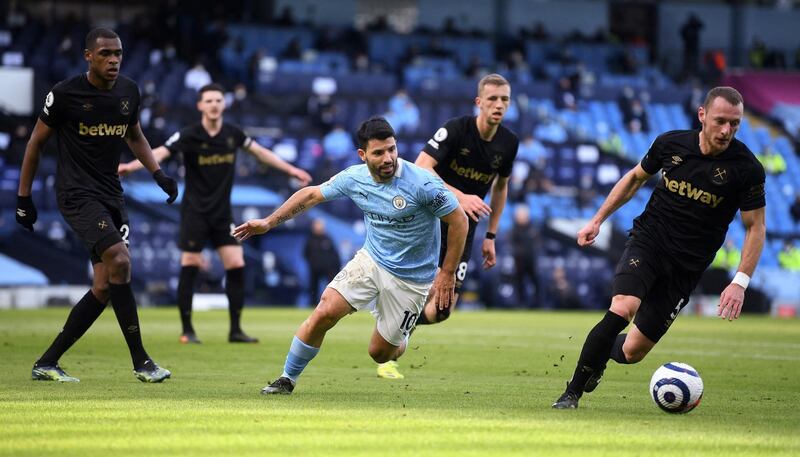 Manchester City's Argentinian striker Sergio Aguero (C) vies with West Ham United's Czech defender Vladimir Coufal (R) during the English Premier League football match between Manchester City and West Ham United at the Etihad Stadium in Manchester, north west England, on February 27, 2021. (Photo by Gareth Copley / POOL / AFP) / RESTRICTED TO EDITORIAL USE. No use with unauthorized audio, video, data, fixture lists, club/league logos or 'live' services. Online in-match use limited to 120 images. An additional 40 images may be used in extra time. No video emulation. Social media in-match use limited to 120 images. An additional 40 images may be used in extra time. No use in betting publications, games or single club/league/player publications. / 