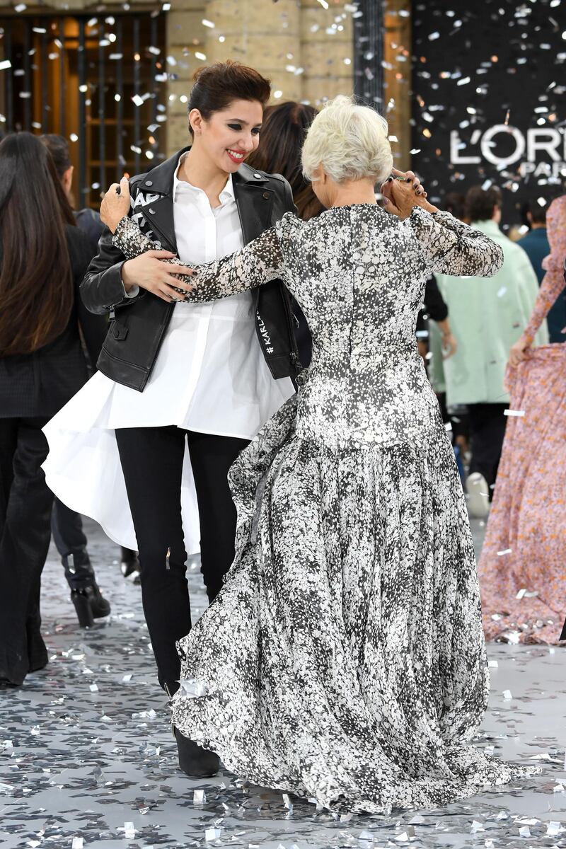 Mahira Khan and Helen Mirren dance on the runway during the L'Oreal Paris show as part of Paris Fashion Week on September 28, 2019. Getty Images
