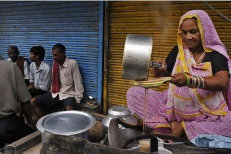 The annual per capita consumption of tea in India is only 300 cups. Above, a roadside seller prepares tea in New Delhi. Tsering Topgyal / AP Photo