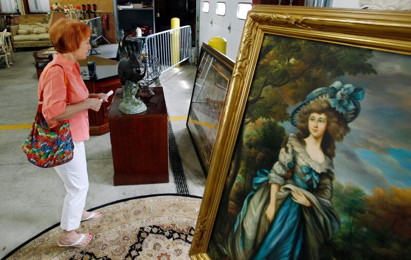 Reenie Harris of Cedar Knolls, New Jersey, admires a large framed antique print during a public viewing of items to be auctioned from the home of former Bernard Madoff finance chief Frank DiPascali in June 2010. The U.S. Marshals Service in New Jersey auctioned 51 lots of items that belonged to DiPascali, one of Madoff's closest associates. AP