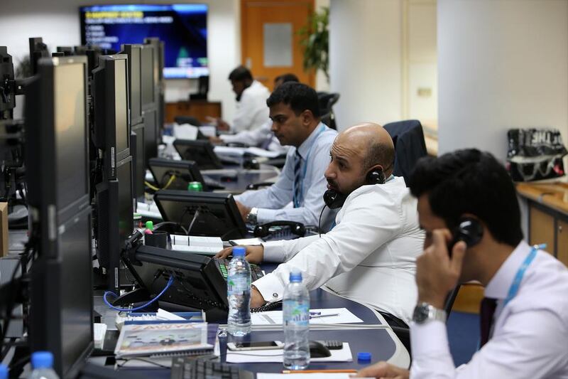Traders at the National Bank of Fujairah office in Dubai. Longer hours don't necessarily lead to greater productivity. (Pawan Singh / The National)