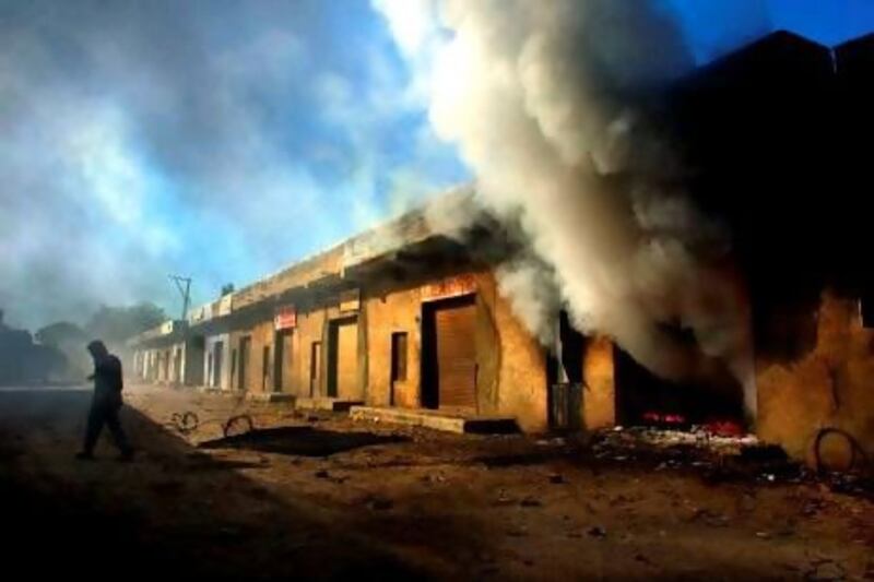 A fire burns in a warehouse in the village of Aslalinaka during Hindu Muslim riots in India in March, 2002. Mr Modi’s alleged association with the riots may prove problematic in the 2014 general elections.