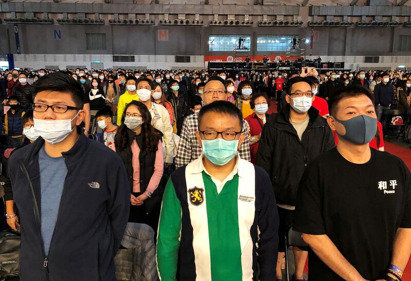 FILE PHOTO: Foxconn employees wearing masks attend the company's year-end gala in Taipei, Taiwan January 22, 2020. REUTERS/Yimou Lee/File Photo