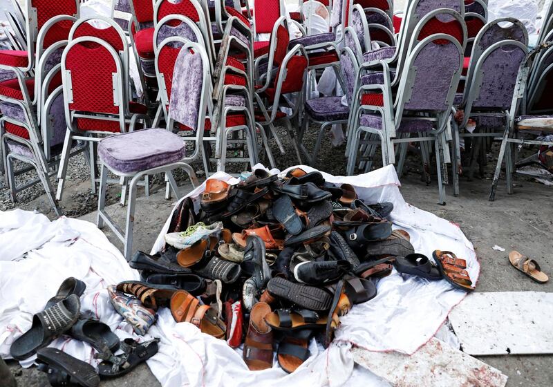 The shoes of victims are seen outside a damaged wedding hall after a blast in Kabul, Afghanistan.  Reuters