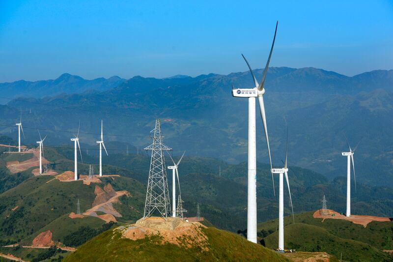 Wind turbines manufactured by Mingyang Electric whirl to generate electricity at a wind farm on the outskirts of Xinyi city, south China's Guangdong province. AP