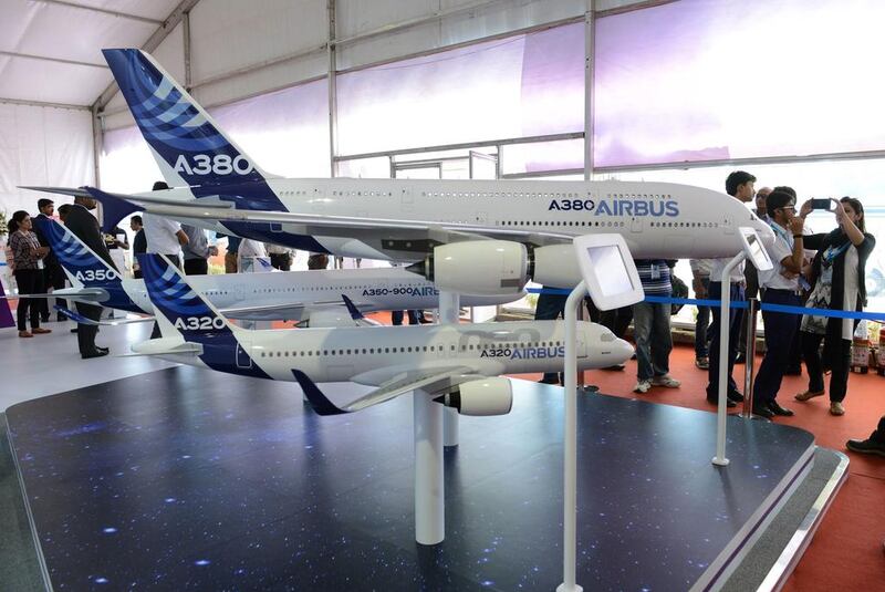 Visitors gather around Airbus A320 and A380 aircraft scale models. Libyan Wings aims to buy aircraft from the A320 family. Noah Seelam / AFP
