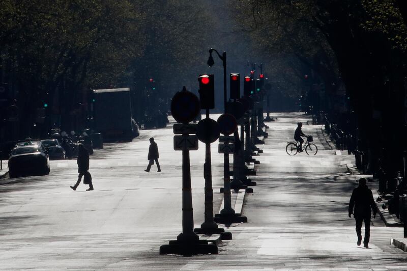 French people walk on the deserted Saint Germain boulevard, in Paris. AP Photo