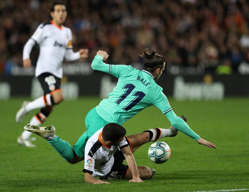 Bale is tackled by Jose Gaya of Valencia. Getty