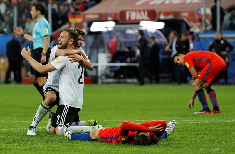 Germany’s Shkodran Mustafi and Jonas Hector celebrate winning the Confederations Cup while Chile’s Alexis Sanchez looks dejected. Darren Staples / Reuters